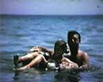 8mm_01_062 Hollywood Beach John and Susan inner tubes, Rosemary, beach